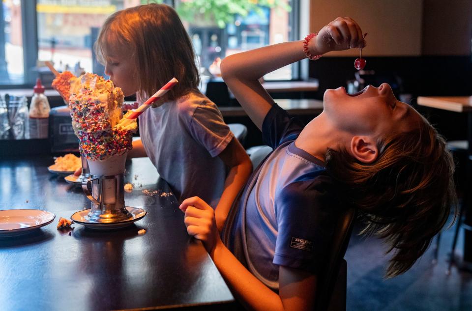 Lily Steineger, left, and Benji Goad try milkshakes at Black Tap Craft Burgers and Beer in Nashville.