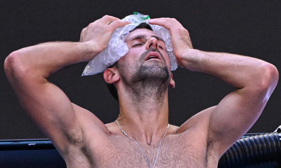 <span>Novak Djokovic uses ice packs on his head between games during this year’s Australian Open.</span><span>Photograph: William West/AFP/Getty Images</span>