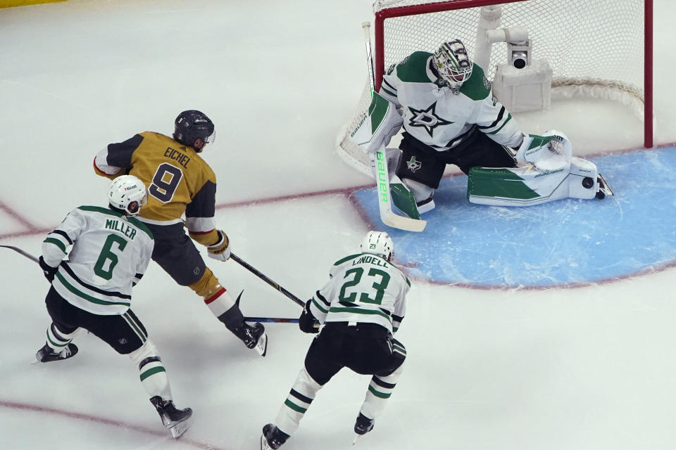 Dallas Stars goaltender Jake Oettinger (29) blocks a shot by Vegas Golden Knights center Jack Eichel (9) during the first period of Game 1 of the NHL hockey Stanley Cup Western Conference finals Friday, May 19, 2023, in Las Vegas. (AP Photo/John Locher)