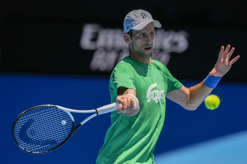 FILE - Defending champion Serbia's Novak Djokovic practices ahead of the Australian Open tennis championship in Melbourne, Australia, Jan. 13, 2022. Weary after two years of some of the harshest COVID-19 border restrictions in the world, many Australians wanted Djokovic kicked out of their country for traveling to the tennis tournament without being vaccinated. But the backdrop to the government's tough line on the defending Australian Open champion and Prime Minister Scott Morrison’s description of the expulsion as a "decision to keep our borders strong" dates to nearly a decade ago. It also shines a light on Australia's complicated, and strongly criticized, immigration and border policies. (AP Photo/Mark Baker, File)