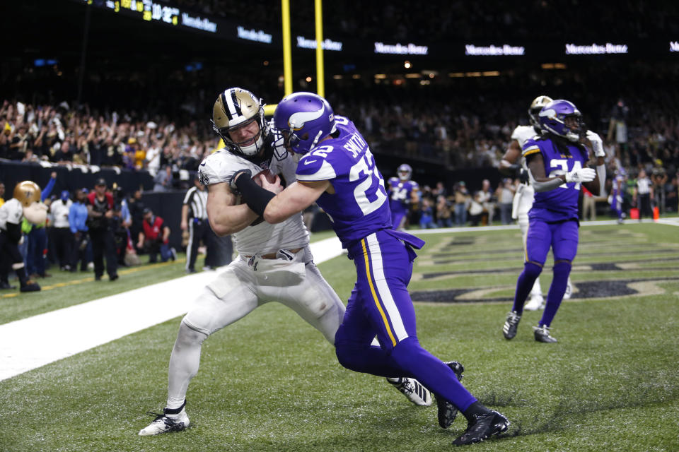 New Orleans Saints Taysom Hill pulls in touchdown reception against Minnesota Vikings free safety Harrison Smith (22) in the second half of an NFL wild-card playoff football game, Sunday, Jan. 5, 2020, in New Orleans. (AP Photo/Brett Duke)