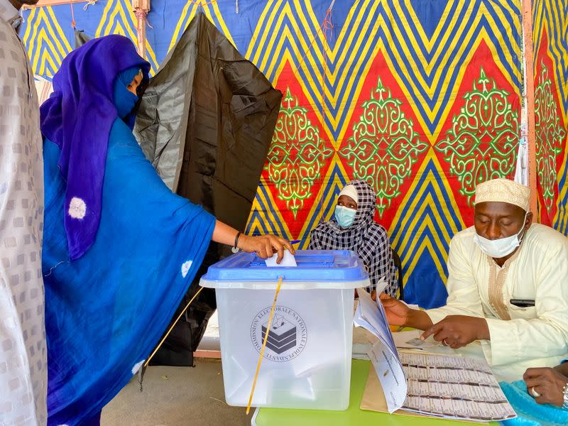 A woman casts her ballot at the pooling station during the presidential election in N'Djamena