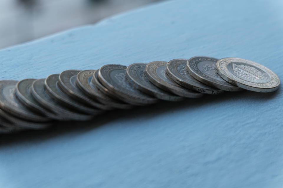 Row of coins on wood background for finance and Saving concept. Earning, accounting