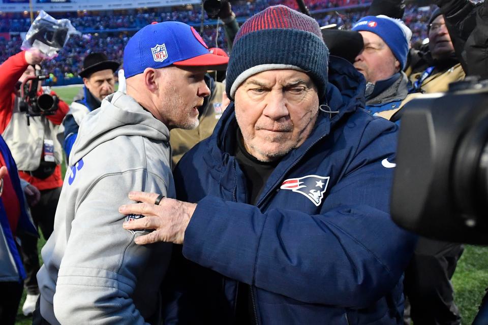 Buffalo Bills head coach Sean McDermott, left, and New England Patriots head coach Bill Belichick, right, part ways after meeting at mid-field following an NFL football game in Orchard Park, N.Y., Sunday, Dec. 31, 2023. (AP Photo/Adrian Kraus)