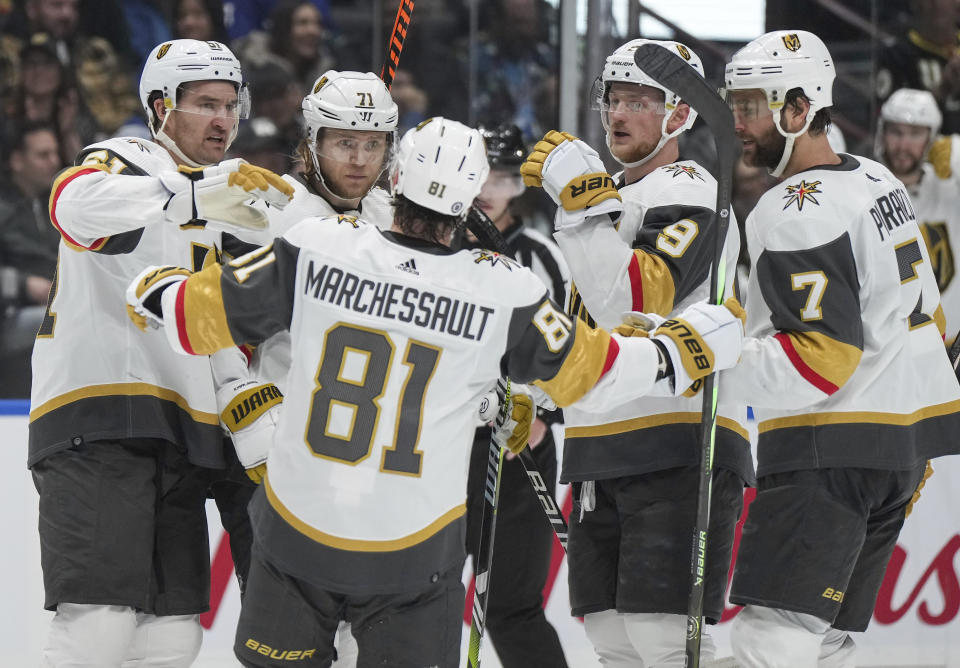 Vegas Golden Knights' Mark Stone, William Karlsson, Jack Eichel and Alex Pietrangelo, from left, and Jonathan Marchessault, front, celebrate Karlsson's goal against the Vancouver Canucks during the second period of an NHL hockey game Thursday, Nov 30, 2023, in Vancouver, British Columbia. (Darryl Dyck/The Canadian Press via AP)