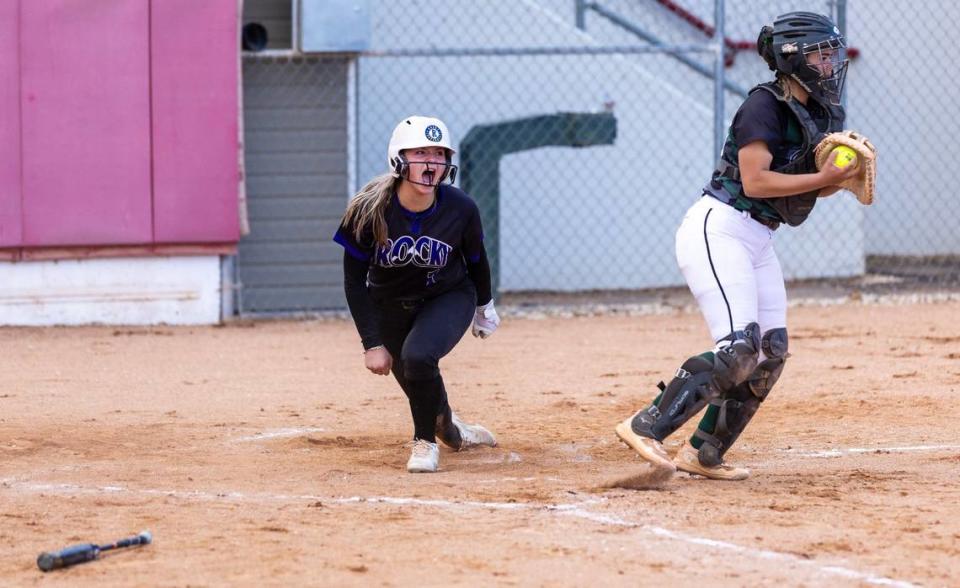 Rocky Mountain senior Airah Whipkey reacts after getting past Eagle catcher junior Emry Woods during the district semifinals May 7.