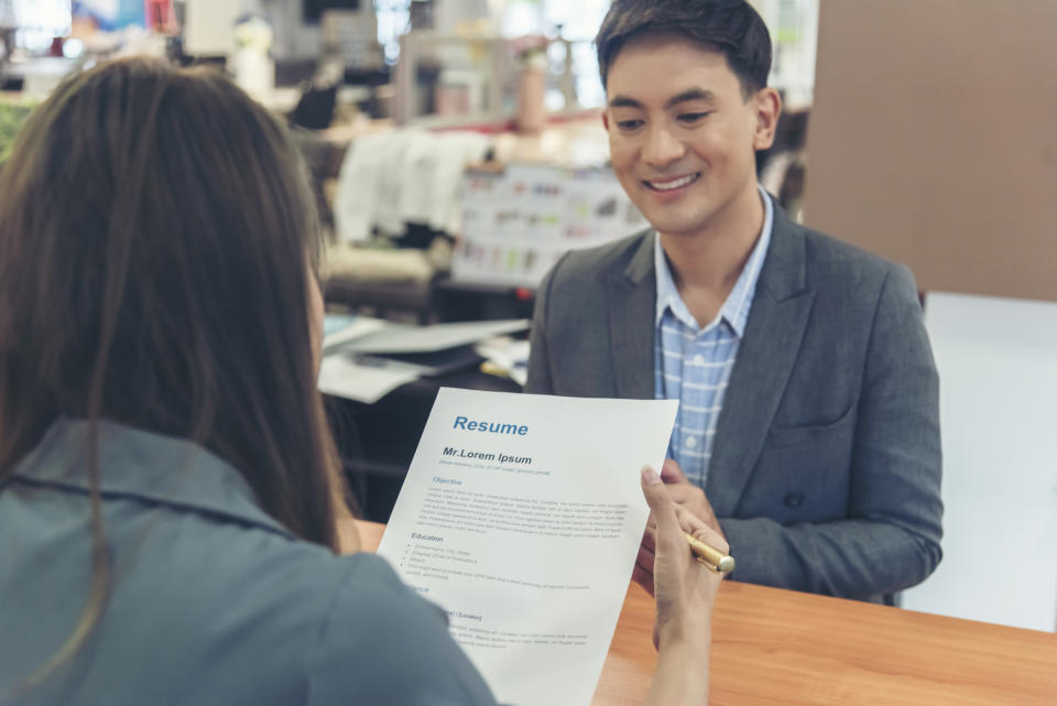 someone reading over a resume during an interview