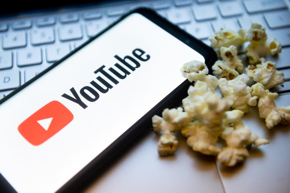 POLAND - 2022/02/03: In this photo illustration a YouTube logo seen displayed on a smartphone
with popcorns and laptop keyboard in the background. (Photo Illustration by Mateusz Slodkowski/SOPA Images/LightRocket via Getty Images)