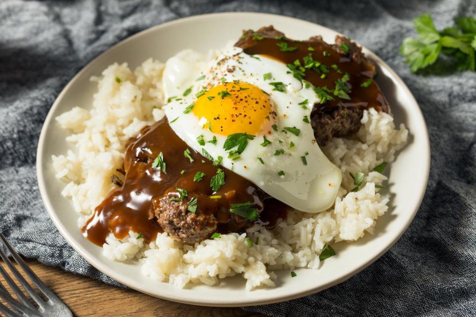 <p>Loco moco is a Hawaiian invention and makes for a great late breakfast after a morning of surfing. It starts with a foundation of white rice, which is then usually topped with a hamburger patty or two, fried eggs, and brown gravy. It’s open to interpretation, however, and the burger patties can be replaced with anything from bacon and <a href="https://www.thedailymeal.com/cook/what-is-spam-recipes?referrer=yahoo&category=beauty_food&include_utm=1&utm_medium=referral&utm_source=yahoo&utm_campaign=feed" rel="nofollow noopener" target="_blank" data-ylk="slk:SPAM;elm:context_link;itc:0;sec:content-canvas" class="link ">SPAM</a> to chili, kalua pork and shrimp.</p>