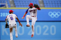 Dominican Republic's Jose Bautista, right, and Erick Mejia celebrate after Dominican Republic won a baseball game against Mexico at Yokohama Baseball Stadium during the 2020 Summer Olympics, Friday, July 30, 2021, in Yokohama, Japan. (AP Photo/Matt Slocum)