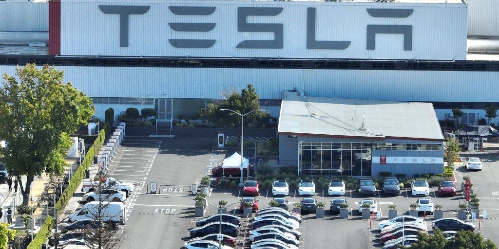 A parking lot outside a Tesla building.