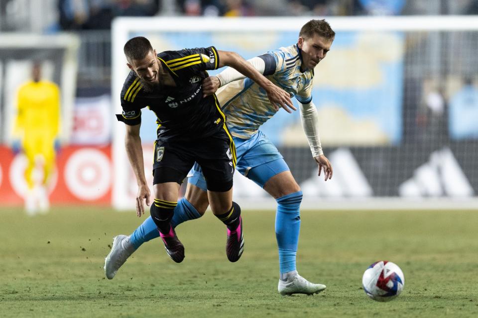 Feb 25, 2023; Philadelphia, Pennsylvania, USA; Columbus Crew SC defender Milos Degenek (5) and Philadelphia Union forward Mikael Uhre (7) battle for the ball during the first half at Subaru Park. Mandatory Credit: Bill Streicher-USA TODAY Sports