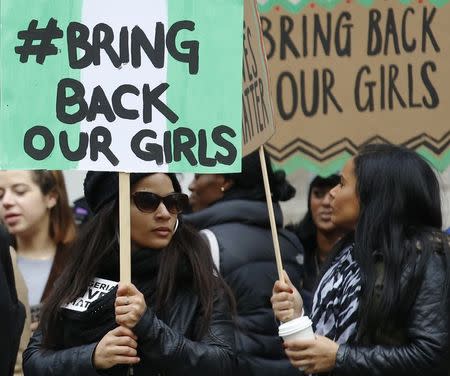 Demonstrators from a group called "Nigeria Matters" hold placards during a rally condemning the lack of a coodinated response to terrorism in Nigeria outside the Nigerian Embassy in London January 25, 2015. REUTERS/Luke MacGregor