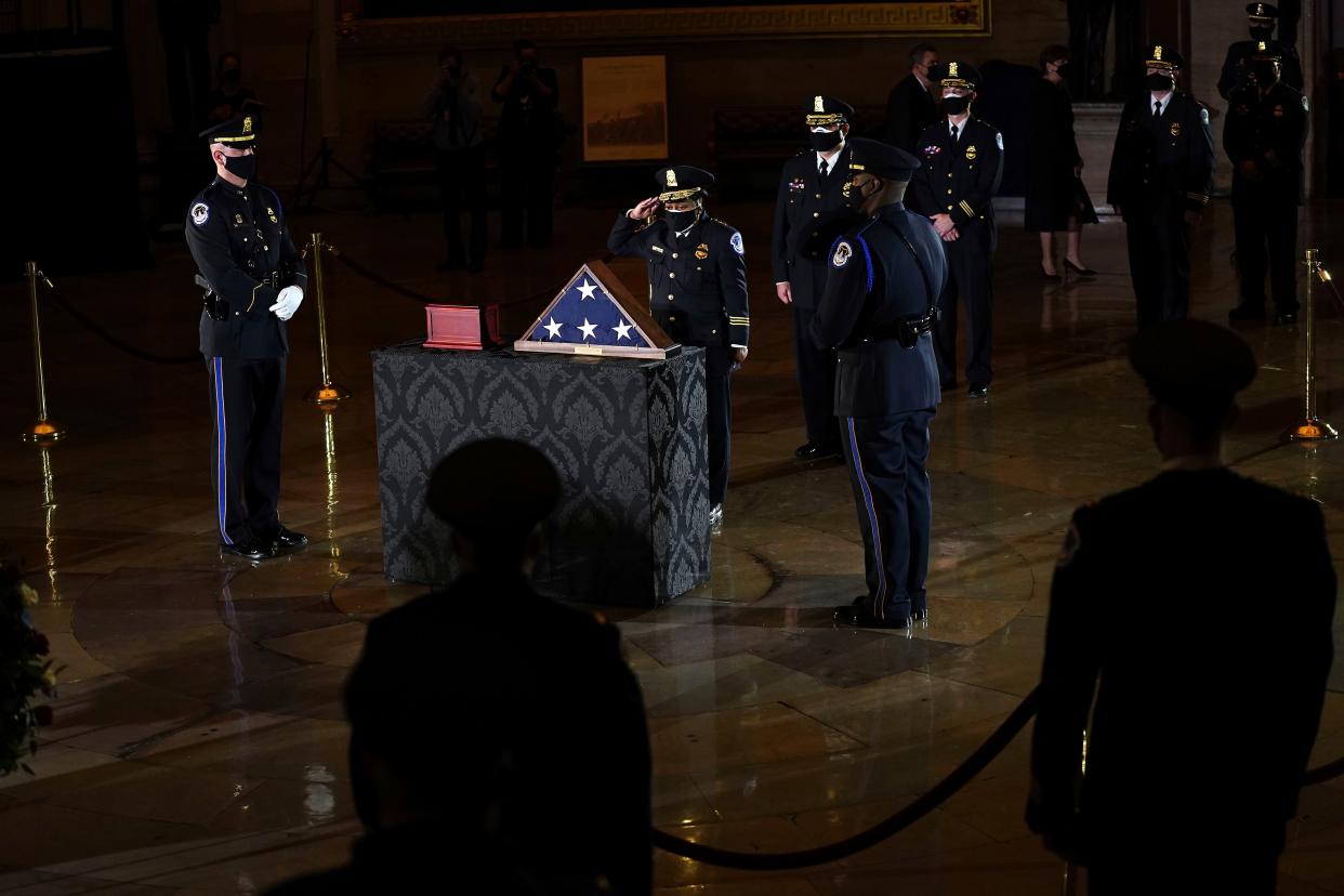 U.S. Capitol Police officers pay their respects to the late U.S. Capitol Police officer Brian Sicknick as an urn with his cremated remains lies in honor on a black-draped table at center of Capitol Rotunda, Tuesday, Feb. 2, 2021, in Washington. 