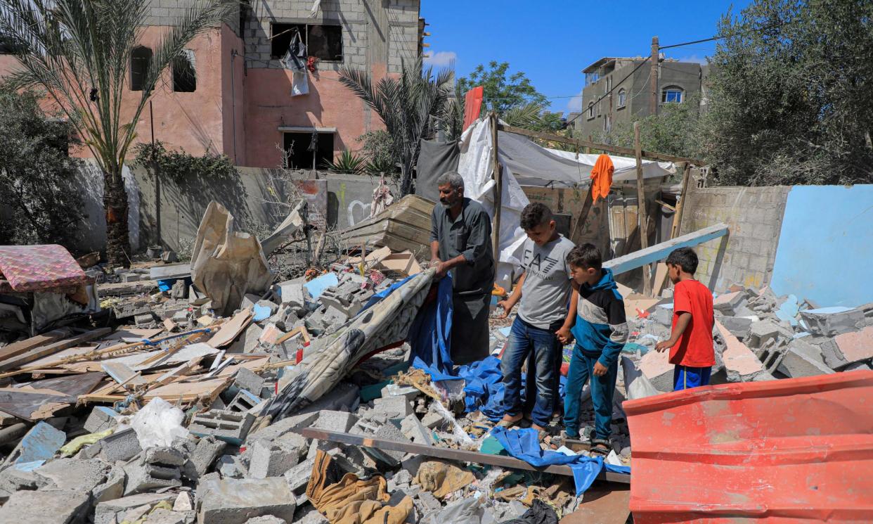 <span>People inspect destroyed houses on 7 May after Israeli attacks in the southern Gaza Strip city of Rafah.</span><span>Photograph: Xinhua/REX/Shutterstock</span>
