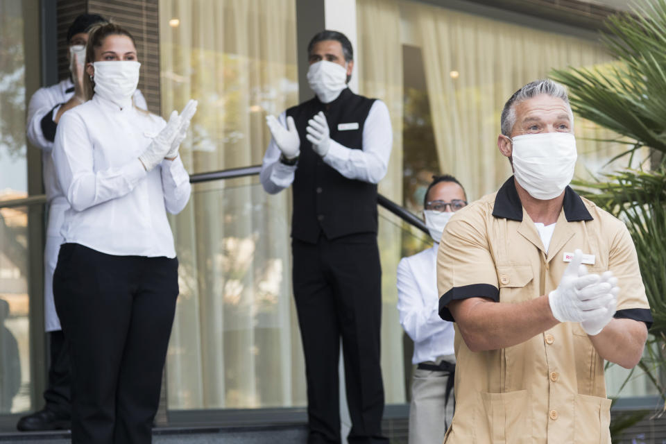 PALMA DE MALLORCA, SPAIN JUNE 15: Workers of the RIU Hotel in Mallorca welcome guests from Dusseldorf Germany on June 15, 2020. They are the first tourists to visit Spain since confinement began due to the COVID-19 crisis. The government of Spain has allowed the entry of 10,900 German tourists to the Balearic Islands on 47 flights throughout the entire month of June to test the viability of tourist recovery. (Photo by Joan Armengual/VIEWpress via Getty Images).