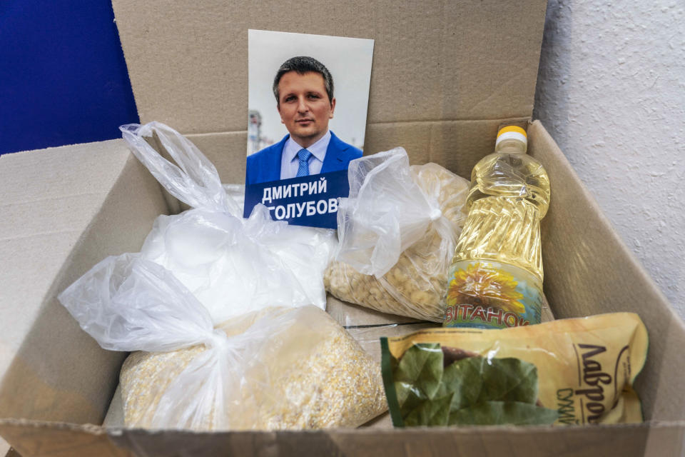 In this photo taken on Friday, July 12, 2019, a portrait of a candidate, packets of grains and food are displayed in an exhibition at the National History Museum, in Kiev, Ukraine. A Darth Vader costume, playground equipment, pastries and boxes of food all are part of an exhibit at Ukraine’s National History Museum displaying the colorful behavior and sometime-questionable practices that characterize the country’s elections. The exhibition, called “The Museum of Election Trash” was put together ahead of the snap parliamentary elections on Sunday, July 21, 2019. (AP Photo/Evgeniy Maloletka)