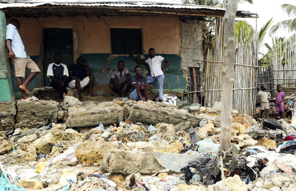 Community members look at rubble and other items washed close to their doorstep when Cyclone Kenneth struck in Pemba city on the northeastern coast of Mozambique, Saturday, April, 27, 2019. Cyclone Kenneth arrived late Thursday, just six weeks after Cyclone Idai ripped into central Mozambique and killed more than 600 people.At least four deaths have been reported in the city and another in hard hit Macomia district, while residents on Ibo Island say two people have died there.(AP Photo/Tsvangirayi Mukwazhi)