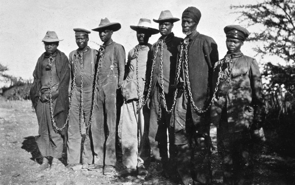 Seven Herero men in chains in what was then German South West Africa - Chronicle / Alamy Stock Photo 