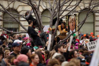 <p>Demonstrators climb a tree with placards as others march on Independence Avenue during the Women’s March on Washington in Washington, DC, January 21, 2017. (JIM WATSON/AFP/Getty Images) </p>