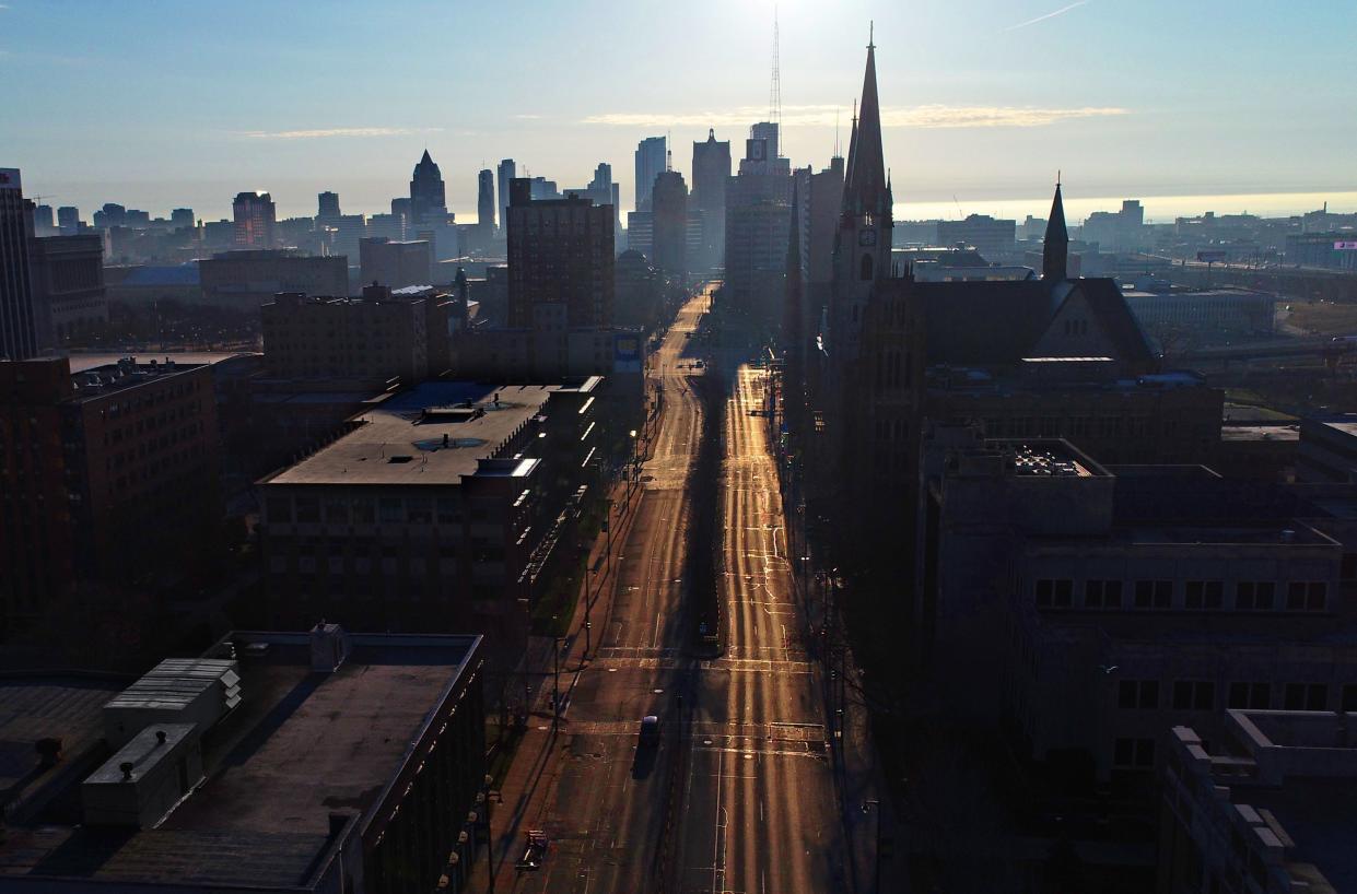 West Wisconsin Avenue is empty of vehicles through Marquette University, just west of the downtown Milwaukee skyline in Milwaukee on Thursday, April 2, 2020.