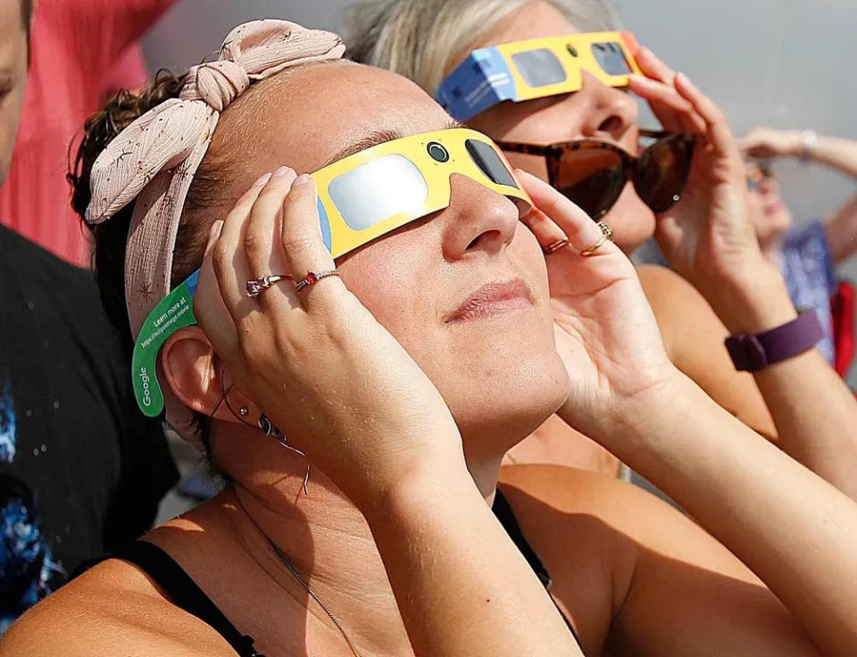 Lindsy Osgood, of Bridgewater, is shown watching the August 2017 solar eclipse through special glasses at Bridgewater State University.