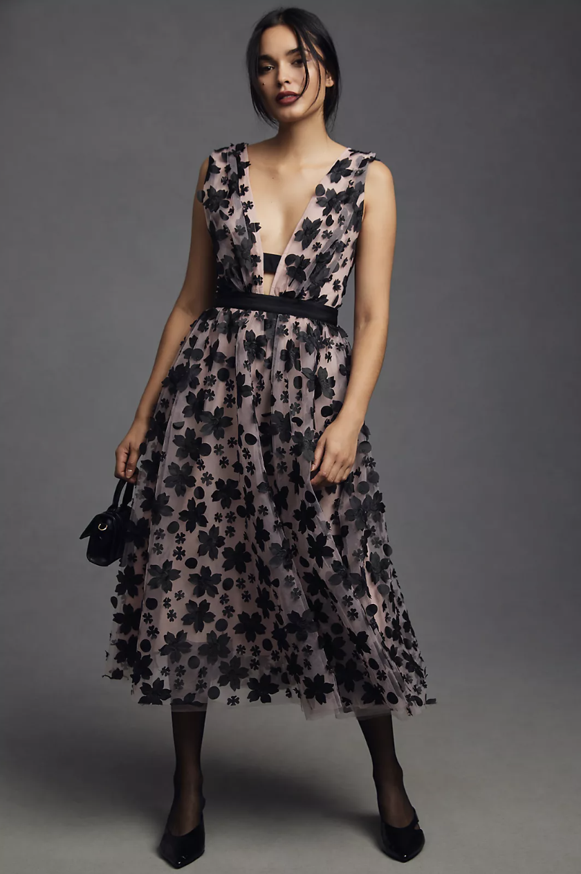 brunette model in pink and black By Anthropologie 3-D Floral Dress (Photo via Anthropologie)