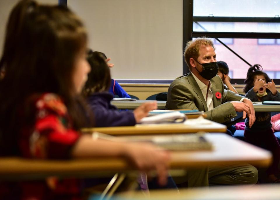 Harry sitting in a classroom full of Afghan children learning English on Joint Base McGuire-Dix-Lakehurst