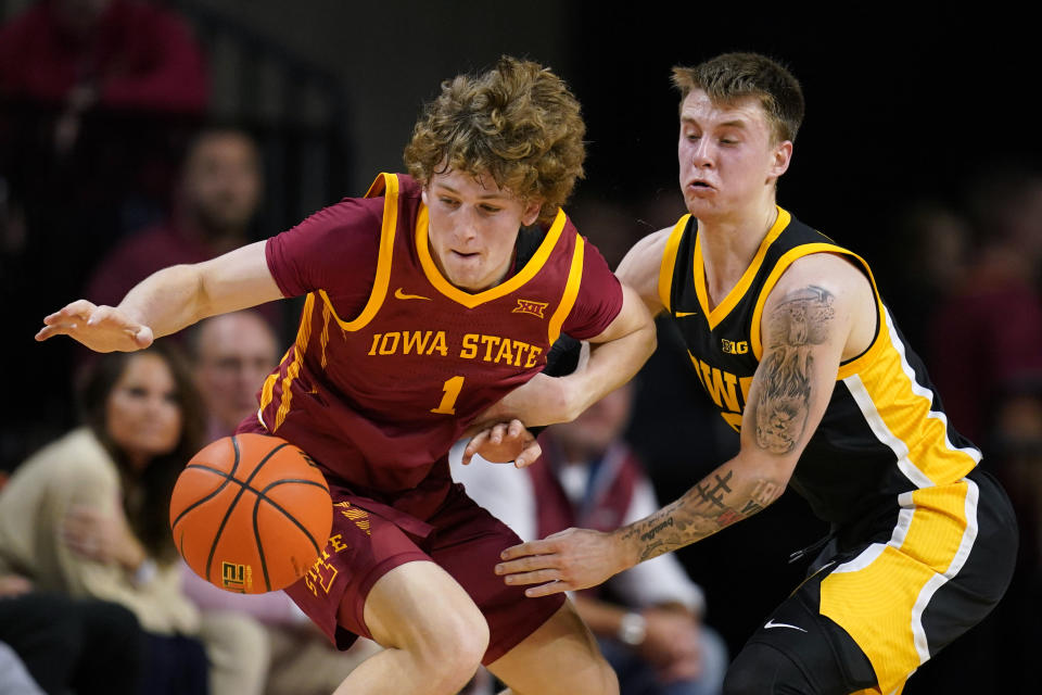 Iowa State guard Jackson Paveletzke (1) fights for a loose ball with Iowa guard Brock Harding, right, during the first half of an NCAA college basketball game, Thursday, Dec. 7, 2023, in Ames, Iowa. (AP Photo/Charlie Neibergall)
