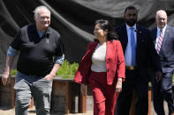 Acting United States Secretary of Labor Julie Su, middle, walks with owner John Balletto, left, before a news conference at Balletto Vineyards in Santa Rosa, Calif., Friday, April 26, 2024. Temporary farmworkers workers are getting more legal protections against employer retaliation, unsafe working conditions, illegal recruitment and other abuses. The rule announced Friday by the Biden administration aims to bolster support workers on H-2A visas. (AP Photo/Jeff Chiu)