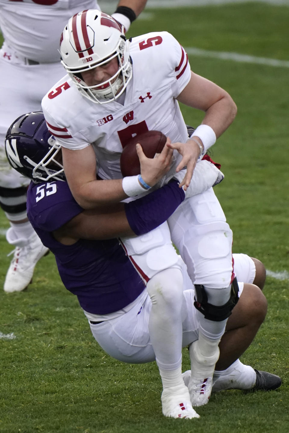 Wisconsin quarterback Graham Mertz is sacked by Northwestern defensive end Eku Leota during the first half of an NCAA college football game in Evanston, Ill., Saturday, Nov. 21, 2020. (AP Photo/Nam Y. Huh)