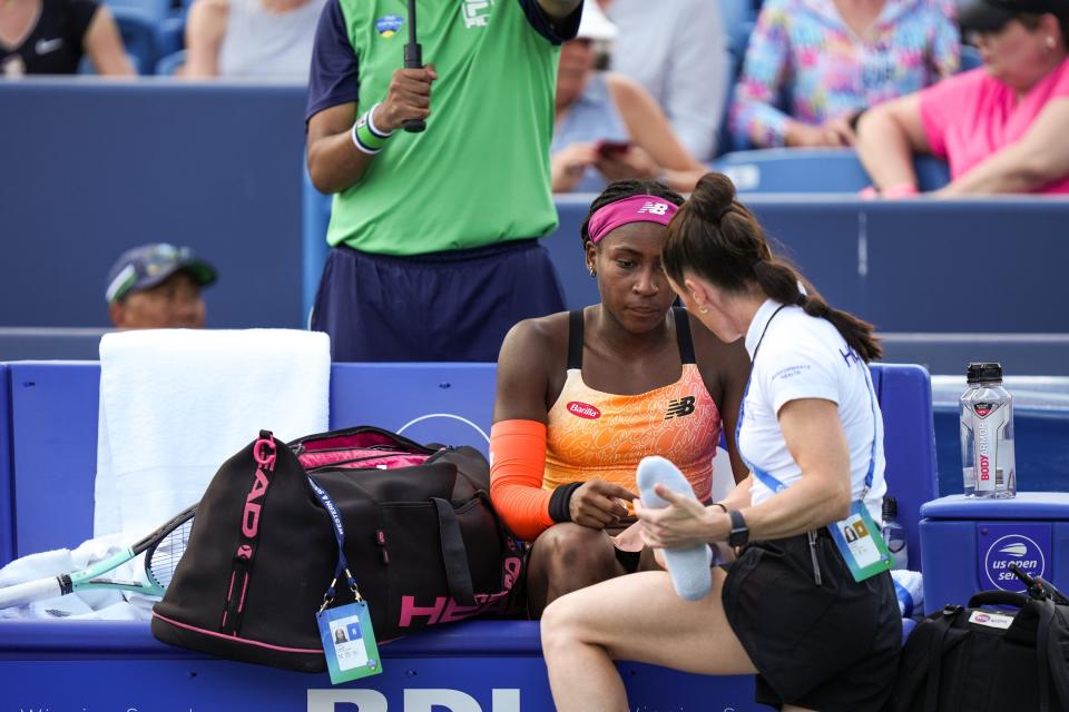 Coco Gauff is tended to between games after falling during her match against Marle Bouzkova.