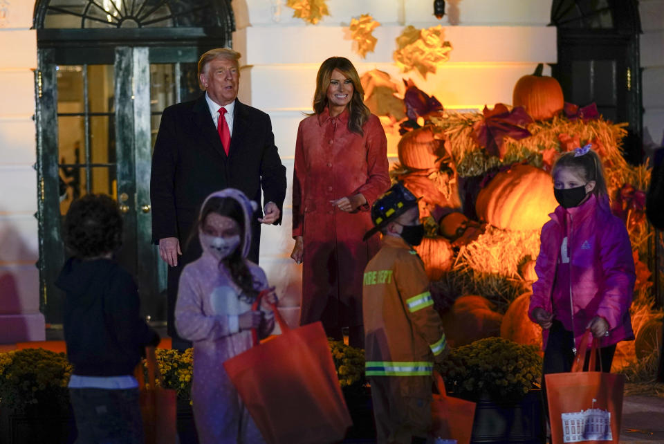 President Donald Trump and first lady Melania Trump greet trick-or-treaters on the South Lawn during a Halloween celebration at the White House, Sunday, Oct. 25, 2020 in Washington. (AP Photo/Manuel Balce Ceneta)