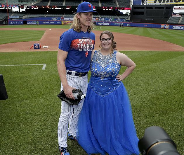 Mets pitcher Noah Syndergaard poses with 17-year-old Callie Quinn, whose request to take her prom photos at Citi Filed garnered over 500,000 retweets. (AP)