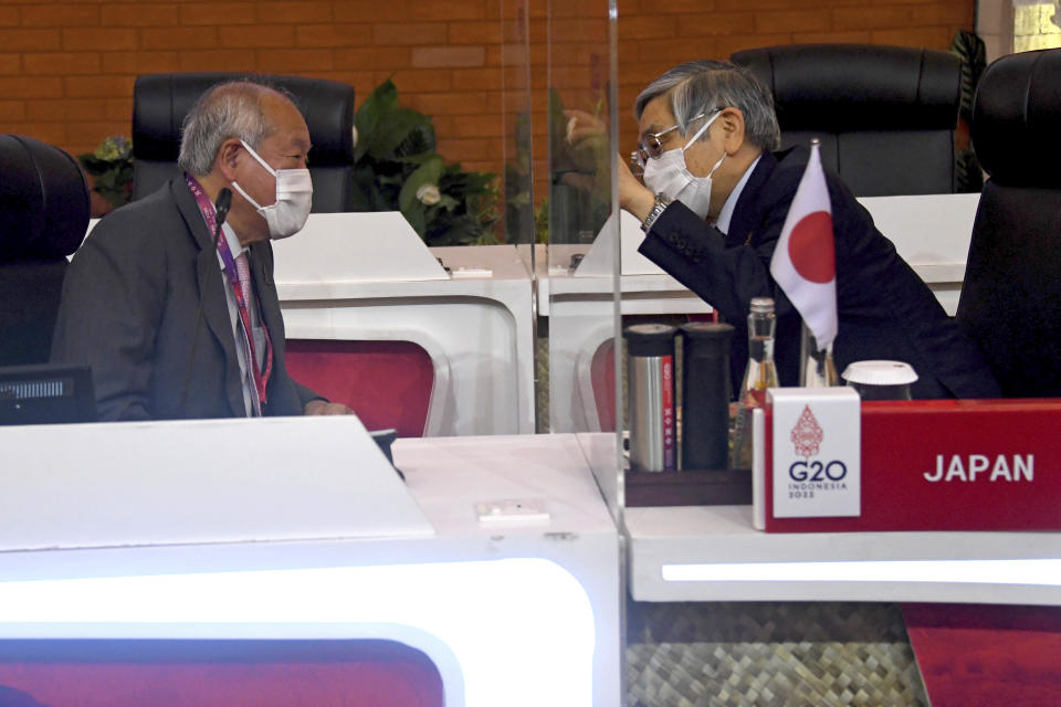 Japanese Finance Minister Shunichi Suzuki, left, talks with Japan's Central Bank Governor Haruhiko Kuroda as they attend the G20 Finance Ministers and Central Bank Governors Meeting in Nusa Dua, Bali, Indonesia, Friday, July 15, 2022. Top financial officials from the Group of 20 leading rich and developing nations are gathering on the Indonesian island of Bali for meetings that begin Friday. (Sonny Tumbelaka/Pool Photo via AP)