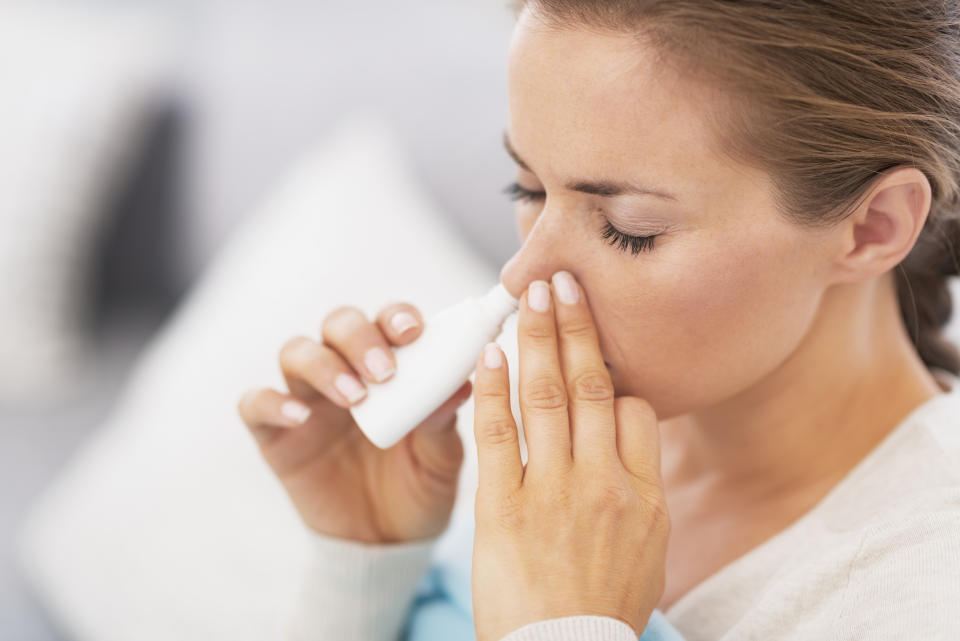 Woman using nasal drops