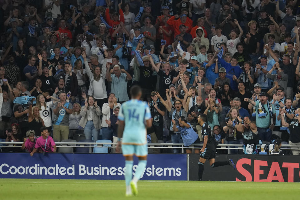 Minnesota United midfielder Emanuel Reynoso, right, celebrates after scoring his second goal during the first half of an MLS soccer match against the Colorado Rapids, Wednesday, Aug. 30, 2023, in St. Paul, Minn. (AP Photo/Abbie Parr)