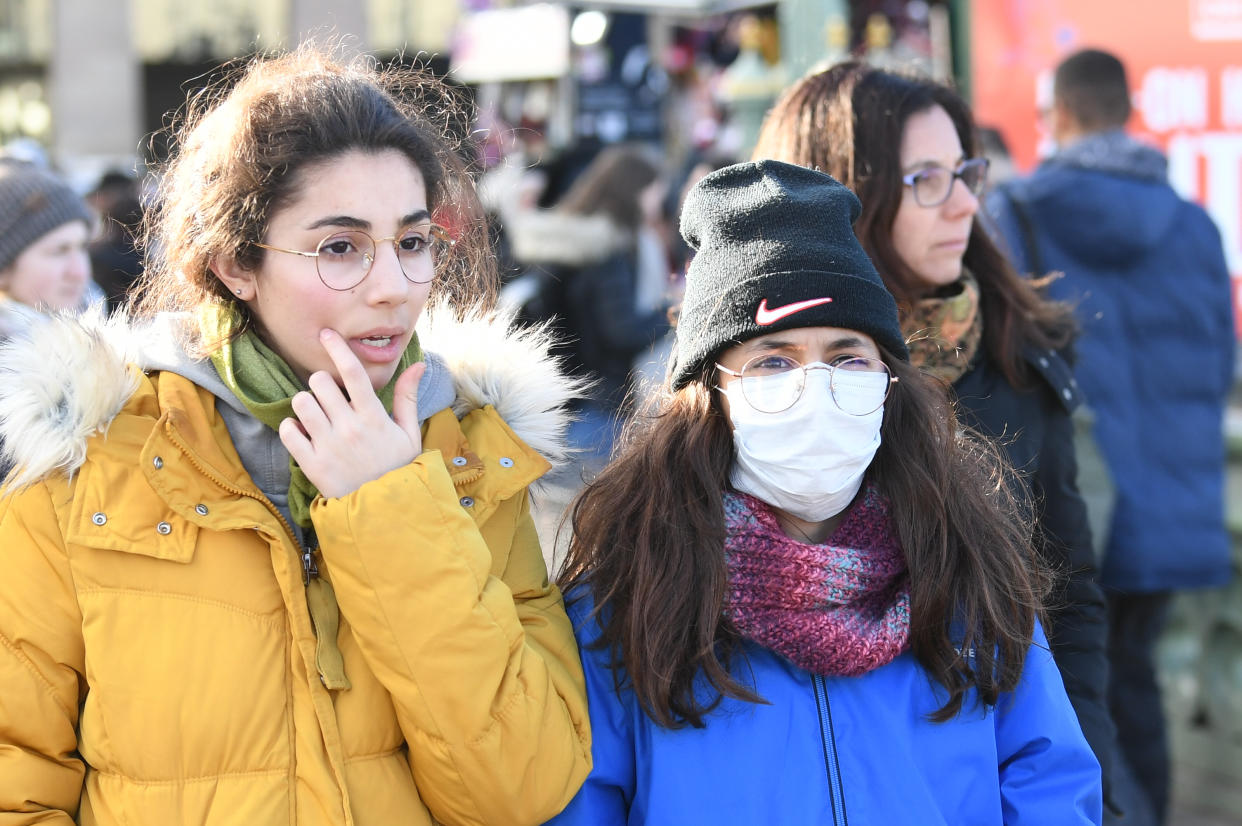 People wearing face masks on Westminster Bridge in London, as Shadow Health Secretary Jonathon Ashworth says he would support shutting down cities to control the spread of coronavirus. (Photo by Stefan Rousseau/PA Images via Getty Images)