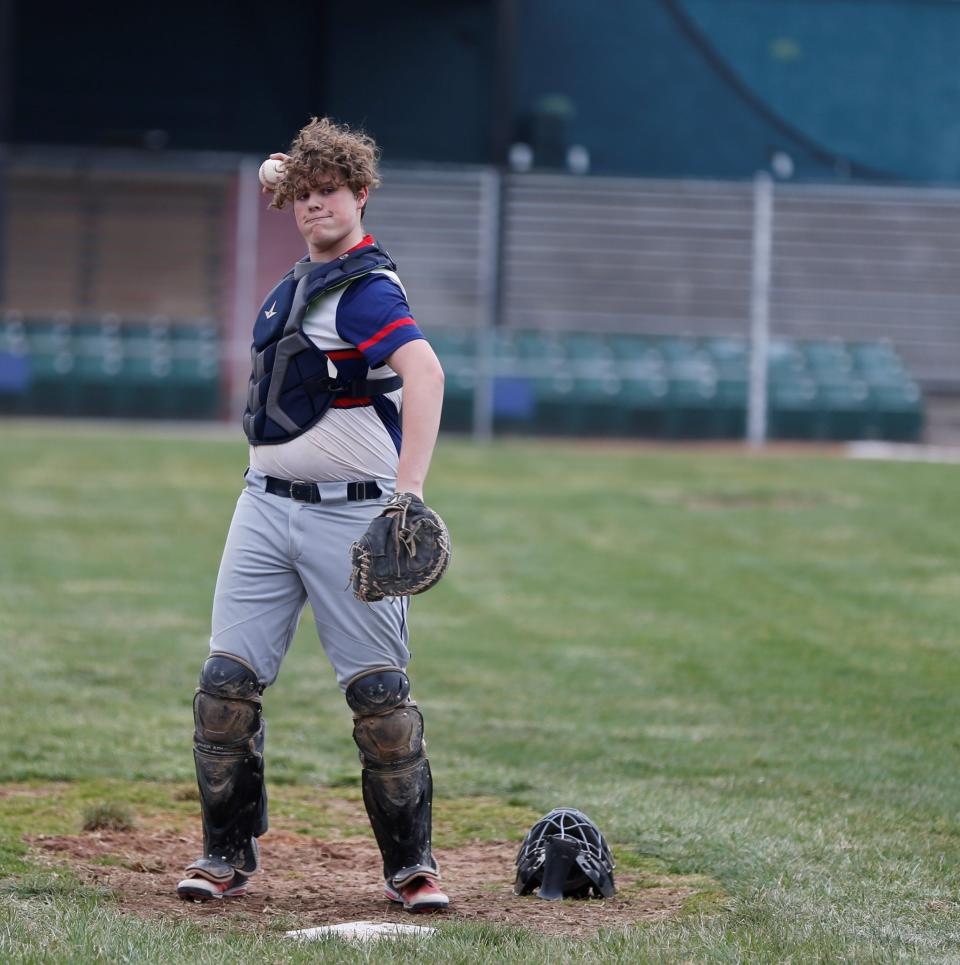 Seton sophomore Nolan Burkhardt warms up the pitcher before a game against Randolph Southern March 30, 2022.