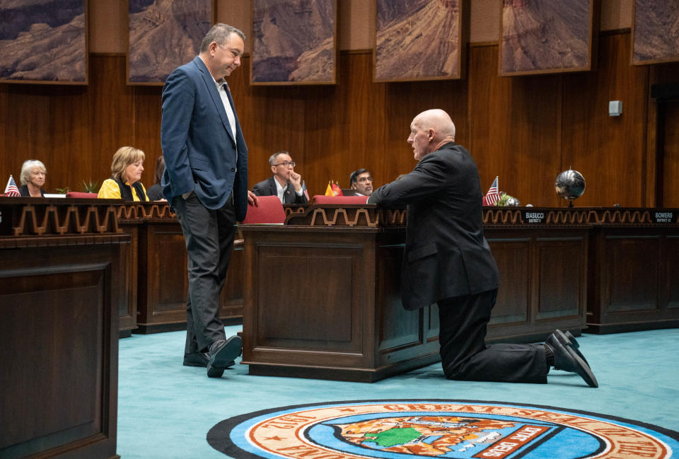 Rep. Rusty Bowers (right) talks with Rep. Ben Toma during a session of the Arizona House of Representatives at the Arizona state Capitol in Phoenix on June 23, 2022.