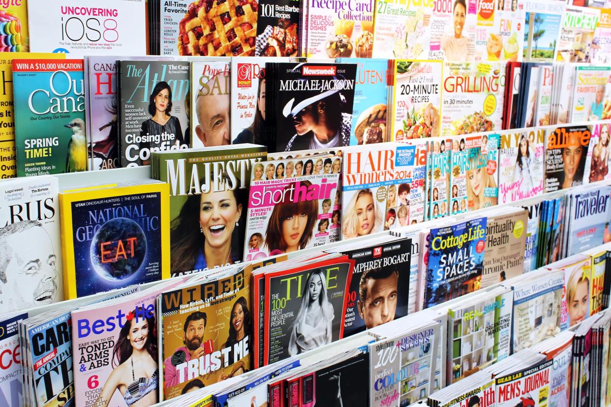 Focus on six rows of trendy magazines including Time, National Geographic, Allure, and more