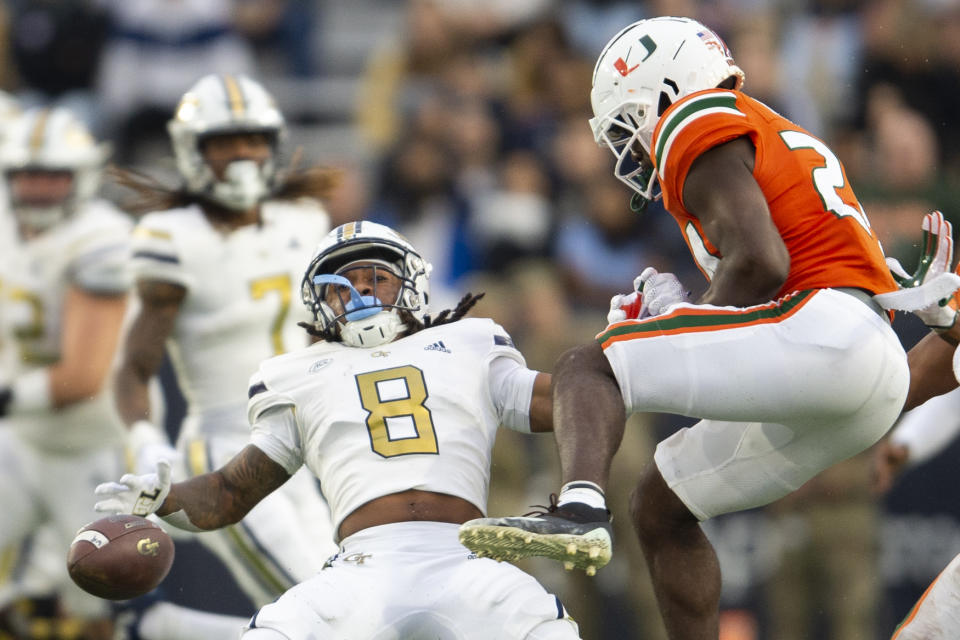 Miami safety Kamren Kinchens, right, breaks up pass intended for Georgia Tech wide receiver Nate McCollum (8) in the first half of an NCAA college football game Saturday, Nov. 12, 2022, in Atlanta. (AP Photo/Hakim Wright Sr.)