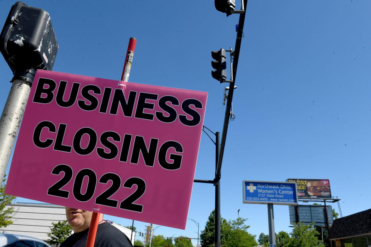 An anti-abortion protester stands outside Northeast Ohio Women's Center in Cuyahoga Falls on the Friday shortly after the Supreme Court overturned Roe V. Wade.