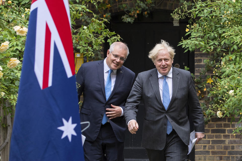 Britain's Prime Minister Boris Johnson, right, walks with Australian Prime Minister Scott Morrison after their meeting, in the garden of 10 Downing Streeet, in London, Tuesday June 15, 2021. Britain and Australia have agreed on a free trade deal that will be released later Tuesday, Australian Trade Minister Dan Tehan said. (Dominic Lipinski/Pool Photo via AP)