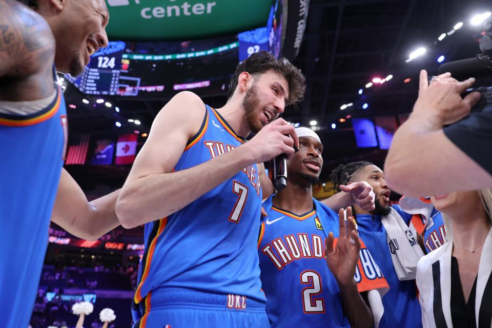 Thunder forward Chet Holmgren (7) takes the microphone beside Shai Gilgeous-Alexander (2) during a postgame interview after Game 2 Wednesday night against the Pelicans.