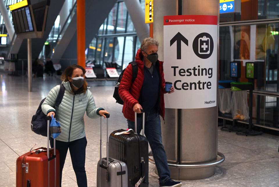 <p>A sign directs passengers to a Covid-19 testing centre at Terminal 5 of Heathrow Airport</p> (AFP/Getty)