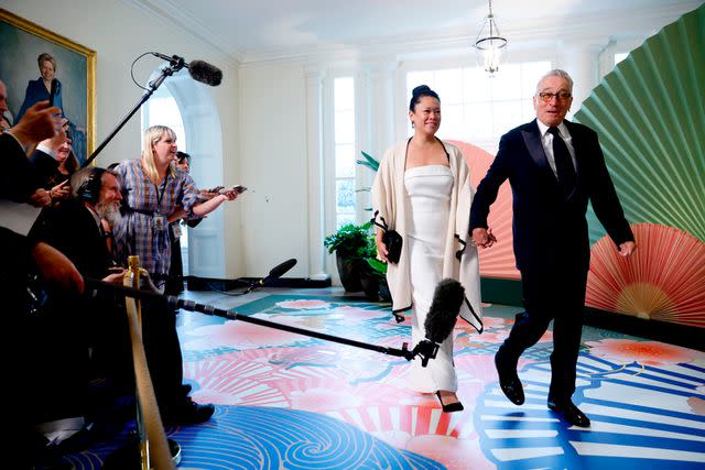 <p>Julia Nikhinson/Bloomberg via Getty</p> Tiffany Chen (L) and Robert De Niro (R) enter the White House state dinner