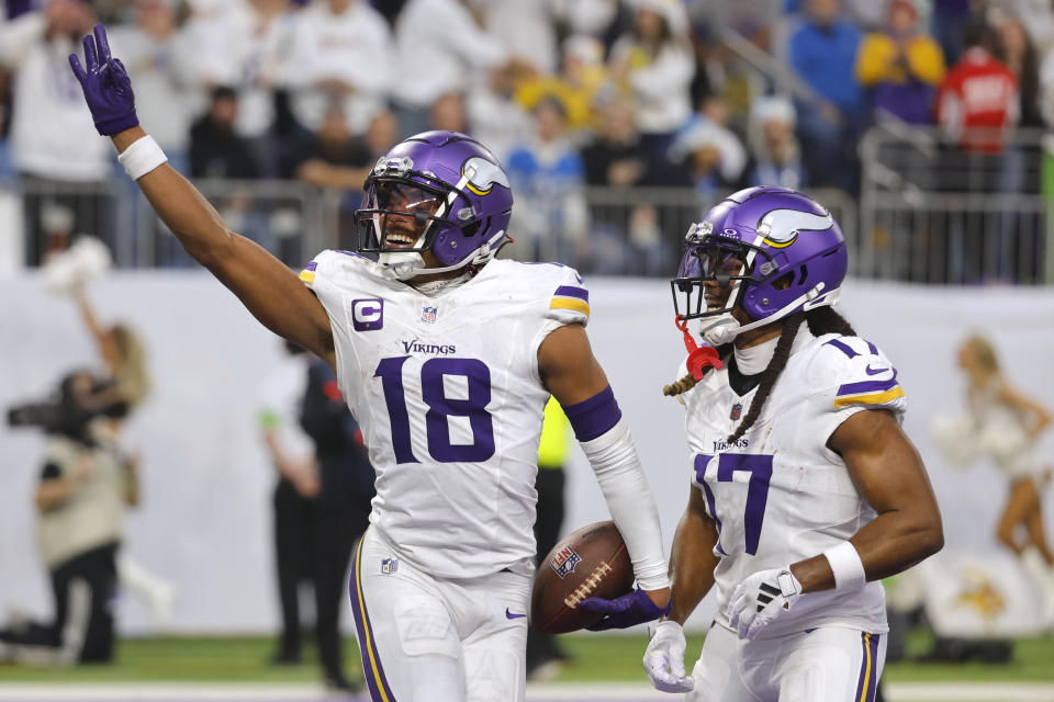 Minnesota Vikings wide receiver Justin Jefferson (18) celebrates with teammate wide receiver K.J. Osborn (17) after catching a 26-yard touchdown pass during the first half of an NFL football game against the Detroit Lions, Sunday, Dec. 24, 2023, in Minneapolis. (AP Photo/Bruce Kluckhohn)