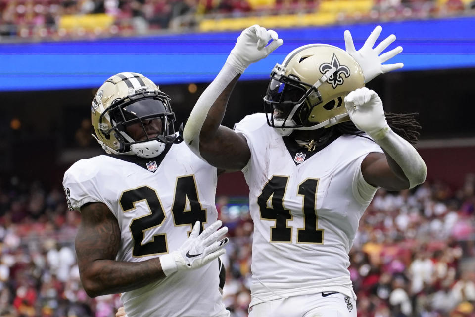 New Orleans Saints running back Alvin Kamara (41) celebrates his touchdown with teammate Dwayne Washington in the first half of an NFL football game against the Washington Football Team, Sunday, Oct. 10, 2021, in Landover, Md. (AP Photo/Alex Brandon)