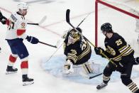 Boston Bruins' Linus Ullmark (35) makes a glove save in front of Florida Panthers' Evan Rodrigues (17) during the second period of an NHL hockey game, Saturday, April 6, 2024, in Boston. (AP Photo/Michael Dwyer)